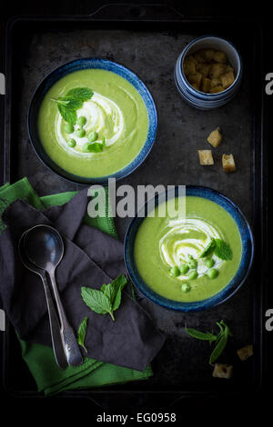 Pea soup served on a dark tray Stock Photo