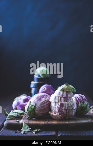 Eggplant, aubergines on a cutting board Stock Photo