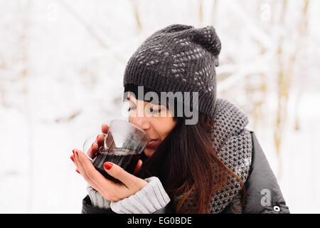 Girl drinking hot tea in winter Stock Photo