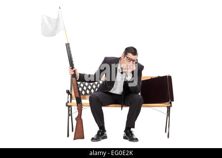 Businessman holding rifle with white flag on it isolated on white background Stock Photo