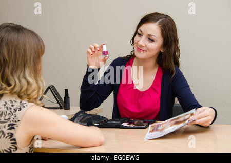 Beauty Consultants offers cosmetics client in the office Stock Photo