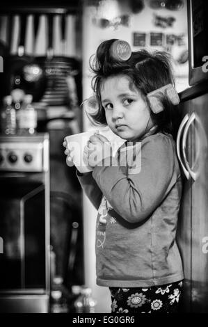 Small girl (4-5) with cup of coffee Stock Photo
