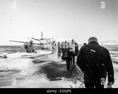 Sweden, Kalmar, Kalmar Airport, Passengers boarding small airplane in winter Stock Photo
