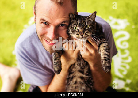 Portrait of man with tabby cat Stock Photo