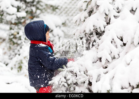 Young boy (4-5) playing outside in winter Stock Photo