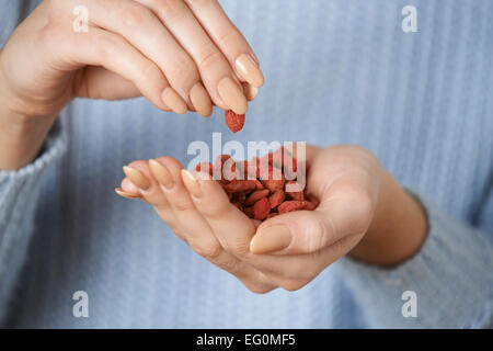 Close Up Of Woman Holding Handful Of Goji Berries Stock Photo