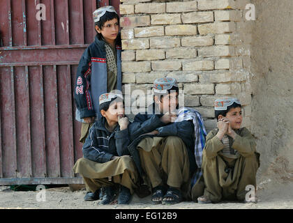 Afghan children watch U.S. Soldiers from 2nd Battalion, 1st Infantry Regiment, 5th Brigade, 2nd Infantry Division conduct a dismounted patrol through the village of Pir Zadeh, Dec. 3, 2009.  U.S.Soldiers are conducting counterinsurgency operations in support of Operation Enduring Freedom.  Staff Sgt. Dayton Mitchell Stock Photo