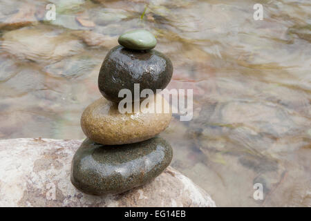 A stone cairn by a river. Stock Photo