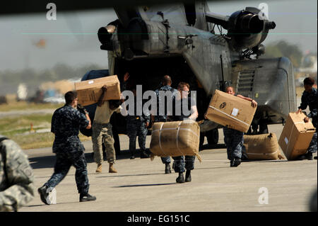 U.S. Navy Sailors off load earthquake relief supplies from a CH-53 Sea Stallion on January 22, 2010 at the Troussaint Louverture International Airport, Haiti for Operation Unified Response.   Master Sgt. Jeremy Lock Released Stock Photo