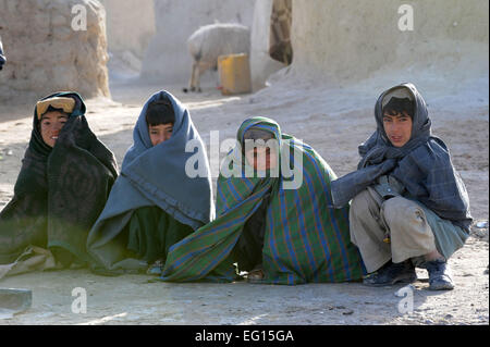 Afghan children watch U.S. Soldiers with Green Platoon, Headquarters and Headquarters Troop, 8th Squadron, 1st Cavalry Regiment visit a Kuchi village near Forward Operating Base Spin Boldak, Afghanistan, Feb. 15, 2010.  Tech. Sgt. Francisco V. Govea II Stock Photo