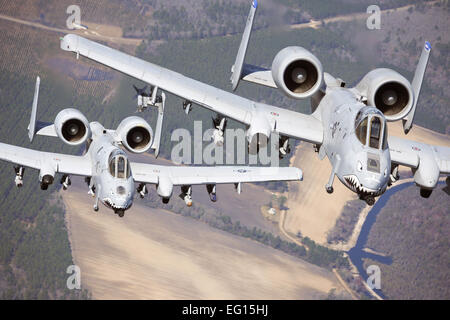 Two A-10C Thunderbolt II aircraft pilots fly in formation during a training exercise March 16, 2010, at Moody Air Force, Ga. Members of the 74th Fighter Squadron performed surge operations to push its support function to the limit and simulate pilots' wartime flying rates.  Airman 1st Class Benjamin Wiseman Stock Photo