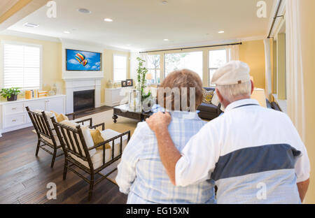 Affectionate Senior Couple Overlooking A Beautiful Custom Living Room. Stock Photo