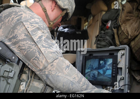 U.S. Air Force Staff Sergeant Christopher Greenfield with Task Force Kandahar, Canadian STAB A, Explosives Ordnance Disposal EOD navigates a rover from his laptop on July 21, 2010 in Kandahar City, Afghanistan.   Technical Sgt. Joselito Aribuabo Stock Photo