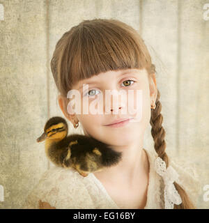 portrait of girl with duckling on shoulder Stock Photo