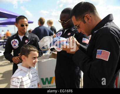 Staff Sgt. Eduardo Sibaja, U.S. Air Force Air Demonstration Squadron &quot;Thunderbirds,&quot; autographs a young fan's hat during the Wings Over Pittsburgh Air Show in Coraopolis, PA, Sept. 12, 2010. Sergeant Sibaja is the assistant dedicated crew chief for Thunderbird 7. Staff Sgt. Larry E. Reid Jr. Stock Photo