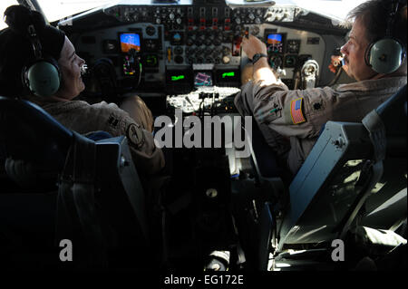 U.S. Air Force Capt. Breanna McNair, 340th Expeditionary Air Refueling Squadron, and Lt. Col. Scott Paffenroth fly a KC-135 Stratotanker during an air refueling mission in support of Operation Enduring Freedom, Sept. 30, 2010.  The aircrew of the KC-135 is deployed from the 91st Air Refueling Squadron at MacDill Air Force Base, Fl.  Staff Sgt. Eric Harris Stock Photo