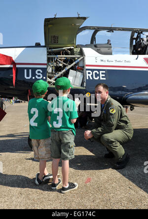 LITTLE ROCK AIR FORCE BASE, Ark. -- Maj. Al Caldwell, 80th Operations Support Squadron chief of student training of Sheppard Air Force Base, Texas, shows off a T-6A Texan II aircraft to William and Andrew Buck Oct. 9 during the Little Rock Air Force Base air show. Approximately 225,000 guests attended the Thunder Over the Rock air show which had more than five hours of flying demonstrations and more than 40 static displays.  Staff Sgt. Chris Willis Stock Photo