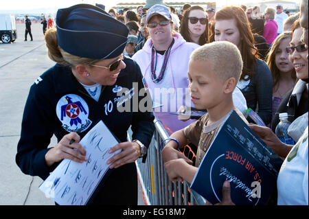 U.S. Air Force Capt. Petrina Hanson, the Thunderbirds executive officer, signs an autograph for a young fan Nov. 14, 2010. The 2010 Aviation Nation Nellis Open House is an opportunity for the Las Vegas community to view aerial demonstrations and static displays of various aircraft from the military. The open house also acts as the final air show of the year for the U.S. Air Force Air Demonstration Squadron, the Thunderbirds.  Airman 1st Class Jamie Nicley Stock Photo