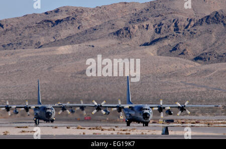 Two C-130 Hercules from the Belgium air force's 20 Squadron taxi on the Nellis Air Force Base, Nev., flight line Feb. 2, 2011, after completing a mission in Red Flag 11-2. The C-130s deployed from Melsbroek Air Base, Belgium, to participate in the combined exercise that provides a realistic combat training environment to the U.S. and its allies.  Staff Sgt. Benjamin Wilson Stock Photo