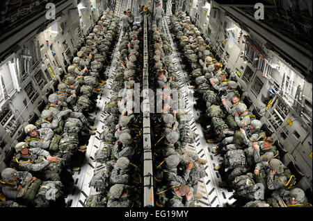 U.S. Army paratroopers from the 82nd Airborne Division sit strapped into a U.S. Air Force C-17 Globemaster III cargo aircraft before they airdrop during the Joint Operational Access Exercise JOAX at Pope Air Force Base, N.C., Feb. 9, 2011. JOAX is a two-week exercise that includes Large Package Week and Joint Operational Access. It includes the 82nd Airborne Division, U.S. Air Force C-130 Hercules and C-17 cargo aircraft and various other Air Force support assets such as security forces, contingency response group, and tactical air control party members.  The exercise prepares Airmen and Soldi Stock Photo