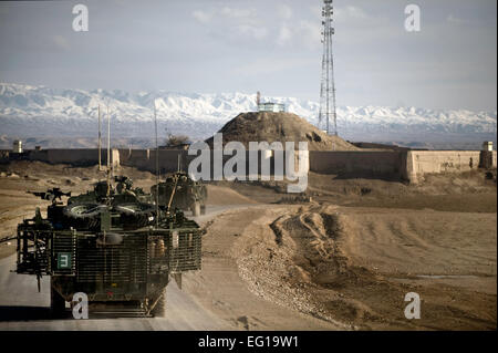 Members of a U.S. Army task force depart a dirt landing zone after securing the surrounding area in the Zabul province of Afghanistan as Airmen from the 807th Expeditionary Air Support Operations Squadron, Forward Operating Base Lagman made sure a dirt landing zone was safe for a C-130 Hercules to land while providing the aircrew with any pertinent information via radio communications. The aircrew was delivering needed cargo for one of the nearby military outposts.  Master Sgt. Adrian Cadiz Stock Photo