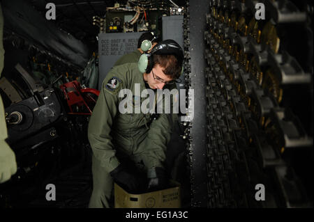 U.S. Air Force Airman John Schade, an AC-130U Spooky aerial gunner assigned to the 4th Special Operations Squadron stows 40mm ammunition in racks aboard a AC-130U aircraft during Emerald Warrior, March 4, 2011, at Hurlburt Field, Fla. Emerald Warrior is a U.S. Special Operations Command-sponsored, multiservice exercise designed to leverage lessons learned from Operations Iraqi Freedom and Enduring Freedom to provide trained and ready forces to combatant commanders.  Tech Sgt. Manuel J. MartinezReleased Stock Photo