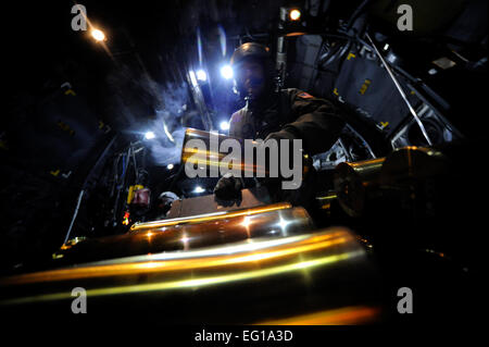 U.S. Air Force Staff Sgt. Tony Taijeron, an aerial gunner assigned to the 4th Special Operations Squadron, prepares to stow an expended 105mm shell while aboard a AC-130U aircraft during Emerald Warrior, March 4, 2011, at Hurlburt Field, Fla. Emerald Warrior is a U.S. Special Operations Command-sponsored, multiservice exercise designed to leverage lessons learned from Operations Iraqi Freedom and Enduring Freedom to provide trained and ready forces to combatant commanders.  Tech Sgt. Manuel J. MartinezReleased Stock Photo