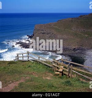 Fence and stile on coast cliff footpath, Cornwall, England Stock Photo