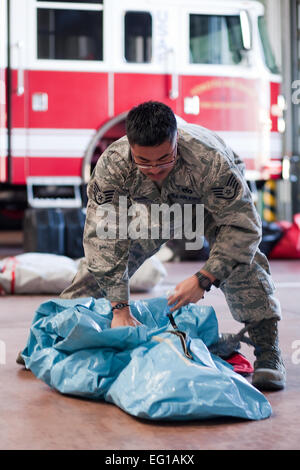 YOKOTA AIR BASE, Japan -- Tech. Sgt. Rommel Fronda, 374th Civil Engineer Squadron, packs a chemical suits, here March 17 to assist Operation Tomodachi. Yokota Firefighters are readiness for support any kind of assistance to host nation. Osakabe Yasuo Stock Photo