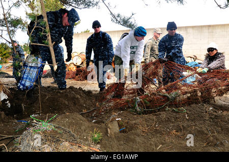 MISAWA AIR BASE, Japan -- Airmen and Sailors help to clean up trash and debris at the Misawa City fishing port Mar. 19. Misawa residents have been volunteering their time to help out the local community since Mar. 14.  Staff Sgt. Marie BrownReleased Stock Photo