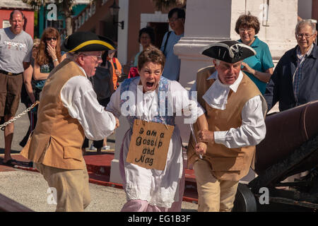A woman is sentenced to the 'The Dunking Stool', as a 'nag and gossip ' in an historical reenactment in St. Georges, Bermuda Stock Photo