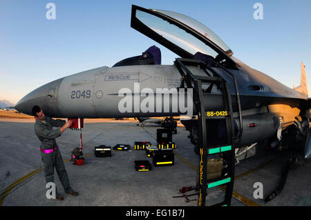 Staff Sgt. Bryan Holloway, 510th Aircraft Maintenance Unit avionics craftsman, performs scheduled radar threat warning maintenance on an F-16 Fighting Falcon March 21, 2011, at Aviano Air Base, Italy. The aircraft will deploy in support of Operation Odyssey Dawn. Joint Task Force Odyssey Dawn is the U.S. Africa Command task force established to support the larger international response to the unrest in Libya.  A broad coalition of nations are partnering to enforce U.N. Security Council Resolution UNSCR 1973, which authorizes all necessary means to protect civilians in Libya under threat of att Stock Photo