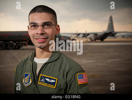 YOKOTA AIR BASE, Japan -- Airman 1st Class Giovanny Miranda, 36th Airlift Squadron loadmaster, stands in front of an R-11 fuel truck and a C-130 Hercules at Yokota Air Base, Japan, March 25. &quot;It's completely amazing to be out in the field doing these missions where you know what you're doing is having an impact on the people who need it most.&quot; Airman Miranda hails from South Milwaukee, Wis. Staff Sgt. Samuel Morse Stock Photo