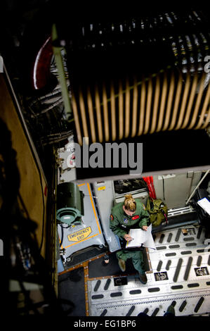 YOKOTA AIR BASE, Japan – Senior Airman Kristina Cyphert, 535th Airlift Squadron, fills out preflight forms on board a C-17 Globemaster III here March 25. The C-17 flew into Marines Corps Air Station Iwakuni to pick up marines from Marine Wing Support Squadron MWSS 171 to drop off them at Sendai Airport. MWSS-171 where heading to Sendai Airport to setup portable showers to bring humanitarian assistance to Japan in part of Operation Tomodachi. Staff Sgt. Jonathan Steffen Stock Photo