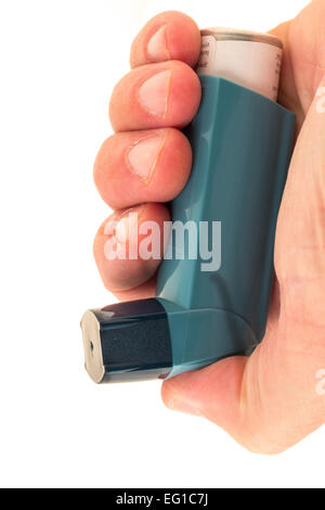 Asthma inhaler in a patients hand - studio shot with a white background Stock Photo