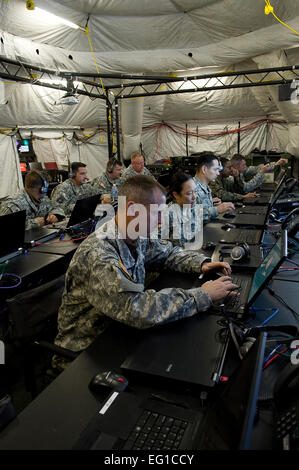YOKOTA AIR BASE, Japan -- Soldiers, Sailors, Airmen and Marines, use the computers provided by the Deployable Joint Command and Control System DJC2, at Yokota. April 1st. The DJC2 was deployed to Yokota to provide communications in support of Operation Tomodachi /Master Sgt. Jeromy K. Cross Stock Photo