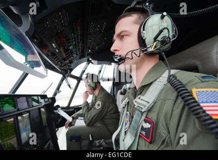 JOINT BASE ELMENDORF-RICHARDSON, Alaska –Air Force Lt. Seth Lake, 41st Airlift Squadron, right and Maj. Joseph Framptom, 19th Airlift Wing, go through their pre-flight checklist  April 4. Their C-130 J Model was from the 19th AW, Little Rock Air Force Base, Arkansas. This They were preparing for a heavy drop and personnel drop performed with 3rd Battalion, 377th Parachute Field Artillery Regiment.  Senior Airman Christopher Gross Stock Photo