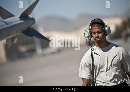 U.S. Air Force Senior Airman Eric McEwen, a crew chief from the 20th Aircraft Maintenance Squadron, Shaw Air Force Base, S.C.,  conducts pre-flight check on a 79th Fighter Squadron F-16 Fighting Falcon for a training mission at Nellis Air Force Base, Nev., during exercise Green Flag West 11-6, April 20, 2011. Green Flag West replicates irregular warfare conditions currently found in Southwest Asia. Aircrews work closely with Air Force joint terminal attack controllers. Pilots train for a missions such as close air support and aerial reconnaissance.  Tech. Sgt. Michael Holzworth Stock Photo