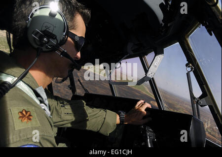 U.S. Air Force Maj. Mark Hutton, 115th Airlift Squadron, California Air National Guard, prepares to drop a line or fire retardant from a C-130J Hercules near Dyess Air Force Base, Texas, April 22, 2011.  The C-130 is equipped with the Modular Airborne Firefighting System which is capable of dispensing 3,000 gallons of water or fire retardant in under 5 seconds.  The fire retardant acts as a barrier preventing wildfires from spreading across it.  Staff Sgt. Eric Harris Stock Photo