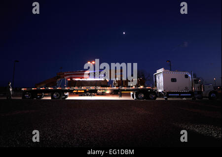 A flatbed truck, carrying pieces of what is believed to be part of the top five floors of the World Trade Center North Tower, stopped at Buckley Air Force Base, Colo.  the night of Aug. 7, 2011. Pieces like these have been stored in Hangar 17 at Kennedy International Airport in an effort by the Port Authority of New York and New Jersey to find final resting places for them in memorials across the country.  Staff Sgt. Kathrine McDowell Stock Photo