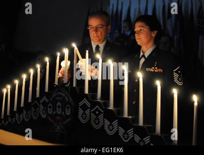 U.S. Air Force Master Sgts. Matthew Marrier and Jessica McBride light candles during the 919th Special Operations Wing’s recent combined Senior Noncommissioned Officer SNCO and NCO induction ceremony Dec. 4, 2011, at Duke Field, Fla. The ceremony honors wing reservists entering the top two tiers of enlisted leadership and signifies their acceptance of increased responsibilities as new SNCOs and NCOs.  Tech. Sgt. Cheryl Foster Stock Photo