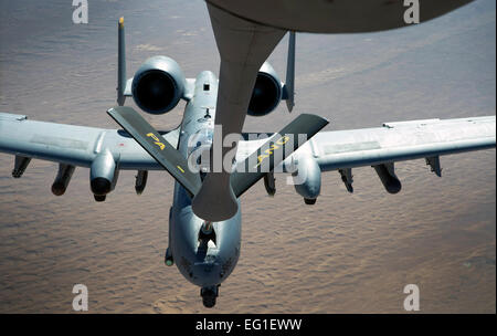 A U. S. Air Force boom operator, with the 340th Expeditionary Air Refueling Squadron, refuels a U.S. Air Force A-10 Thunderbolt II ground attack aircraft Jan. 28, 2012, over Southwest Asia. A three-Airman crew recently deployed from the 171st Air Refueling Wing out of Pittsburgh, Pa., with the Pennsylvania Air National Guard.  Staff Sgt. Sara Csurilla Stock Photo