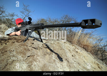 U.S. Air Force Senior Airman Tara Langella sights a .50-caliber sniper rifle at Francis S. Gabreski Air National Guard Base in Westhampton, N.Y., March 14, 2012.  Senior Airman Christopher S. Muncy Stock Photo