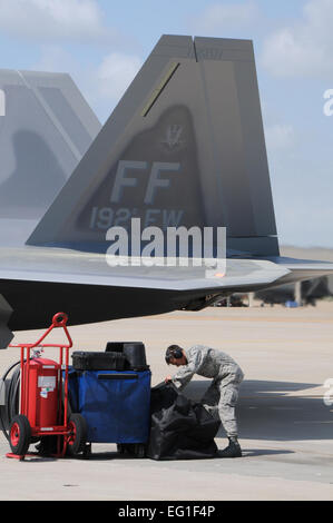 U.S. Air Force Senior Airman Adam Hamel prepares to perform maintenance on the wing's flagship F-22 Raptor fighter aircraft at Langley Air Force Base, Va., March 22, 2012. The aircraft bears tail number 09-0192, which shares the namesake of the Virginia Air National Guard unit. Hamel is a 192nd Fighter Wing F-22 Raptor assistant crew chief. Air National Guard photo by Master Sgt. Carlos J. Claudio Stock Photo