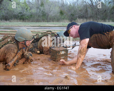 Airmen from the 3rd Combat Communications Group participate in the individual movement course during Combat Readiness School at Tinker Air Force Base, Okla., March 23, 2012. During the school, the Airmen learn skills in base defense, patrols and Level 1 of the modern Army combatives program. Stock Photo