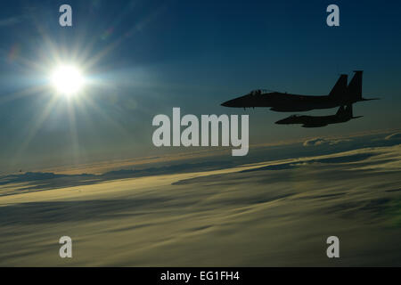 Two F-15C Eagles, deployed from Royal Air Force Lakenheath, England, perform a mock aerial interception on a KC-135 Stratotanker while flying over Iceland Nov. 21, 2013. The 48th Air Expeditionary Group has been maintaining the North Atlantic Treaty Organization air surveillance and policing mission in Iceland since Oct. 28, 2013.  Airman 1st Class Dana J. Butler Stock Photo