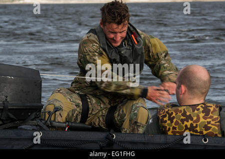 A U.S. Air Force Airman from the 23rd Special Tactics Squadron pulls a start chord on the boat engine during personal recovery using alternate infiltration and exfiltration training on Wynnehaven Beach, Fla., April 9, 2013. The 23rd STS performs austere airfield control, terminal attack control, personnel rescue and recovery, assault zone assessment, battlefield trauma care, direct action and special reconnaissance.  Airman 1st Class Christopher Callaway Stock Photo