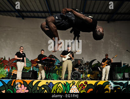 The U.S. Air Forces in Europe and Air Forces Africa rock band, &quot;Afterburner&quot; performs for more than 60 children while gymnasts fly through the air during a concert at an orphanage June 18, 2014, in Dakar, Senegal. USAFE-AFAFRICA Airmen are in Senegal for the African Partnership Flight, a program designed to improve communication and interoperability between regional partners in Africa. The band will be playing multiple venues in the area to inspire children and musicians through the universal language of music.  Staff Sgt. Ryan Crane Stock Photo