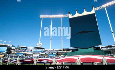 Airmen hold the American flag during the Royals vs. Orioles baseball game at Kaufmann Stadium in Kansas City, Mo., Oct. 15, 2014. The Airmen are assigned to the 509 and 131st Bomb wings at Whiteman Air Force Base, Mo. A B-2 Spirit stealth bomber made an appearance during the pre-game activities, representing the U.S. Air Force to a packed stadium as well as a TV viewership of millions during Game 4 of the American League Championship Series.  Staff Sgt. Brigitte N. Brantley Stock Photo