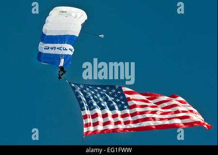 A U.S. Air Force Academy cadet from the Wings of Blue demonstration team displays the American flag during the Aviation Nation opening ceremony at Nellis Air Force Base, Nev., Nov. 11, 2012. Members of the Wings of Blue team serve primarily as instructors and jump masters for the Air Force basic free-fall course AM490.  Airman 1st Class Jason Couillard Stock Photo